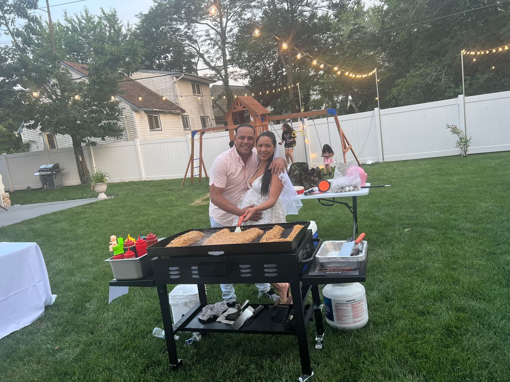 backyard hibachi setup with grill cart and guests